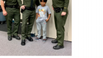 OCSD officers pose for photo with child