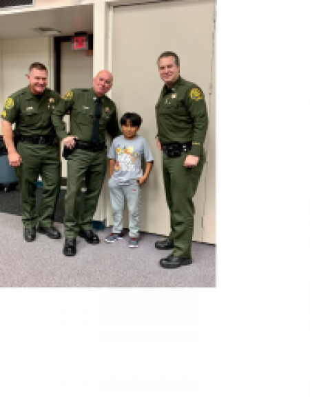 OCSD officers pose for photo with child