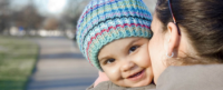 Woman kissing a baby's cheek